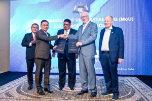 Datuk Mohd Yusof and Peter Nussbaum exchange signed Memorandum of Understanding